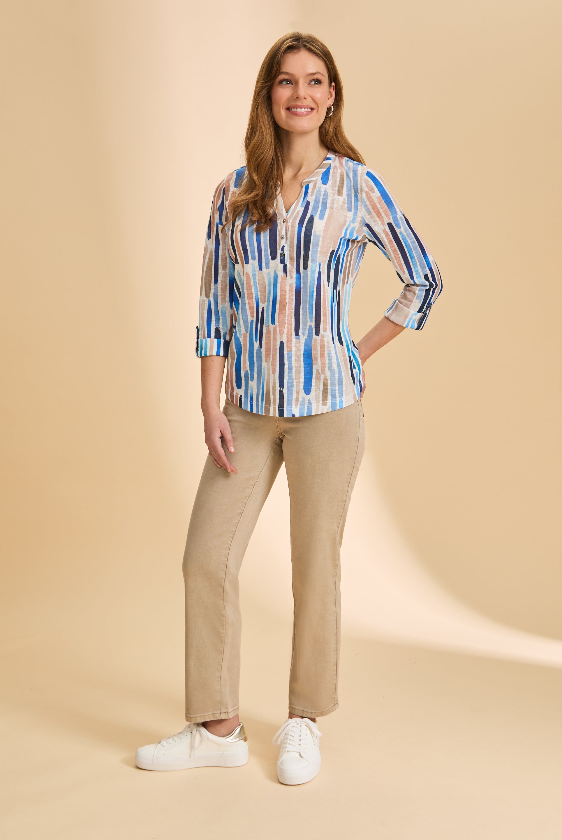 Full body view of blue stripe Henley top with beige pants and casual sneakers by French Dressing Jeans (FDJ)