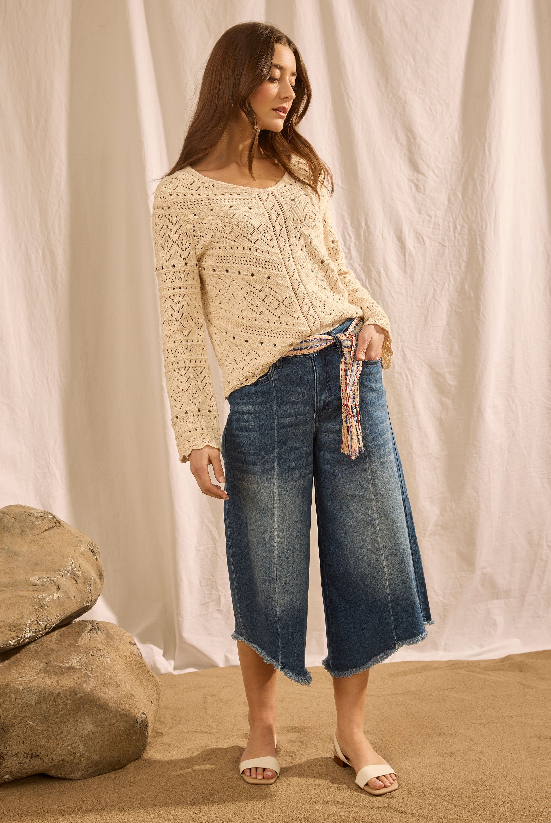 Full-body view of denim culottes with crochet top on sandy background by French Dressing Jeans (FDJ)