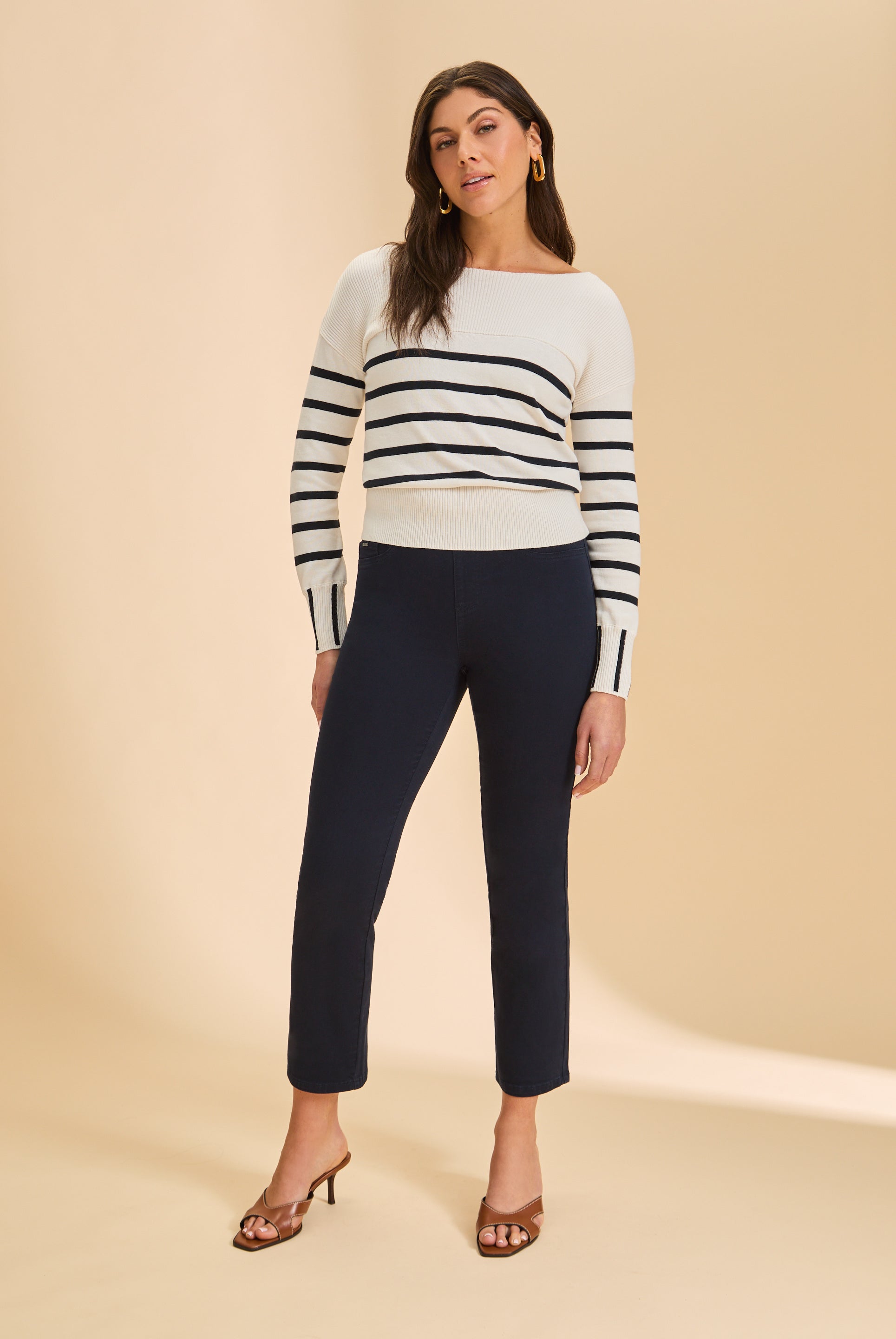 Full view of white/black stripe sweater paired with dark pants by French Dressing Jeans (FDJ)