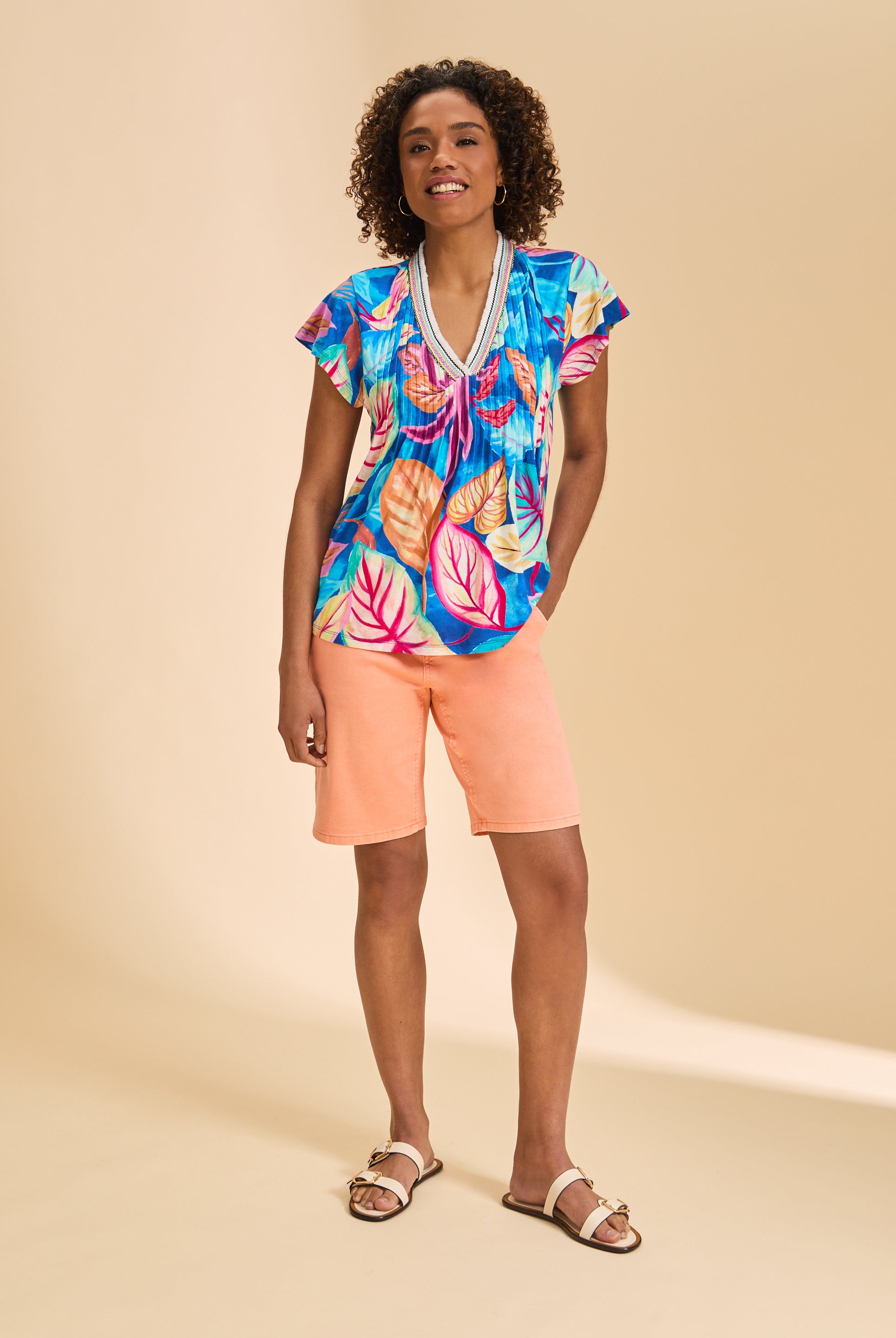 Full front view of Flutter Sleeve Pintuck Top paired with peach shorts by French Dressing Jeans (FDJ)