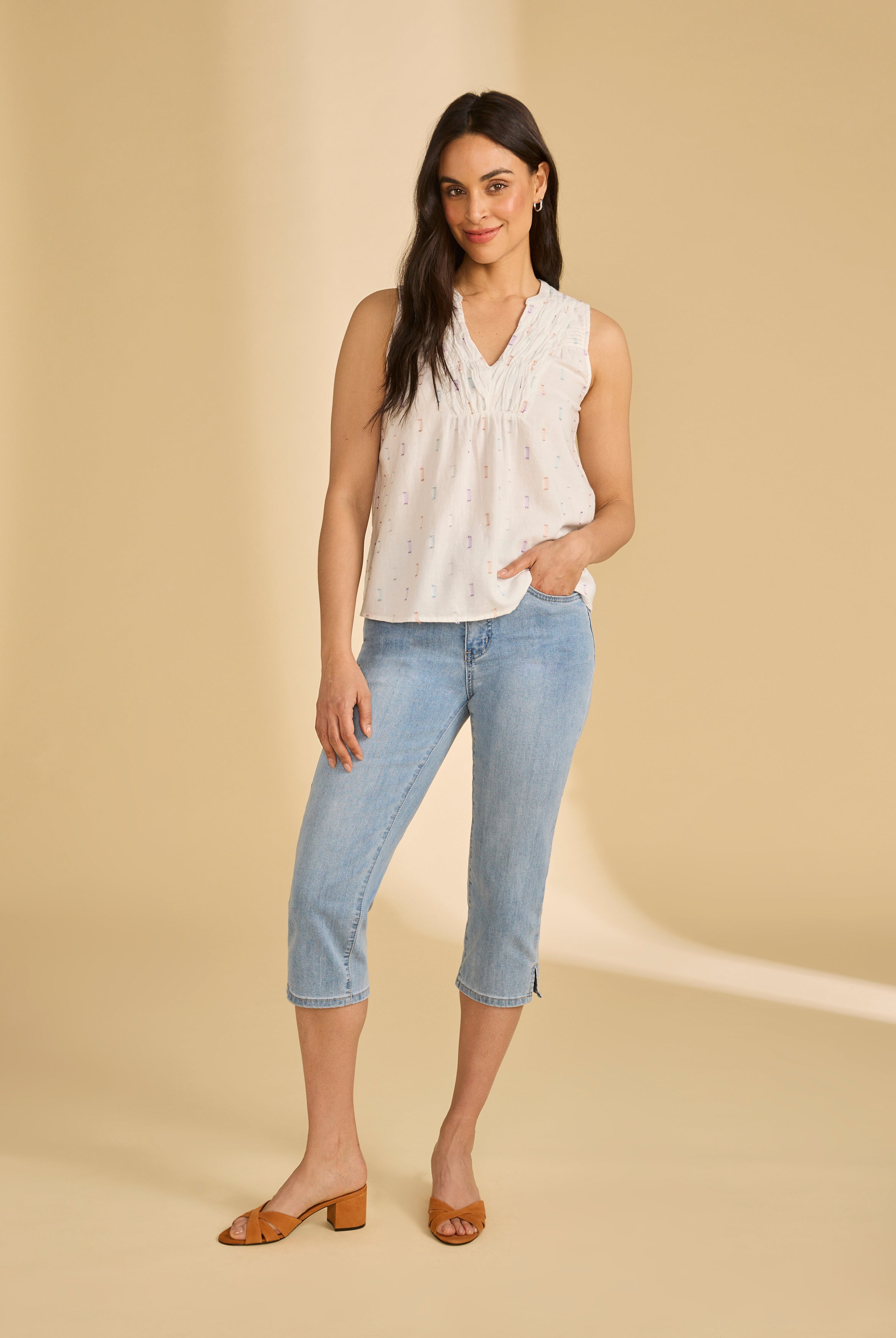 Full view of white sparkle sleeveless blouse paired with jeans, showing relaxed fit, by French Dressing Jeans (FDJ)