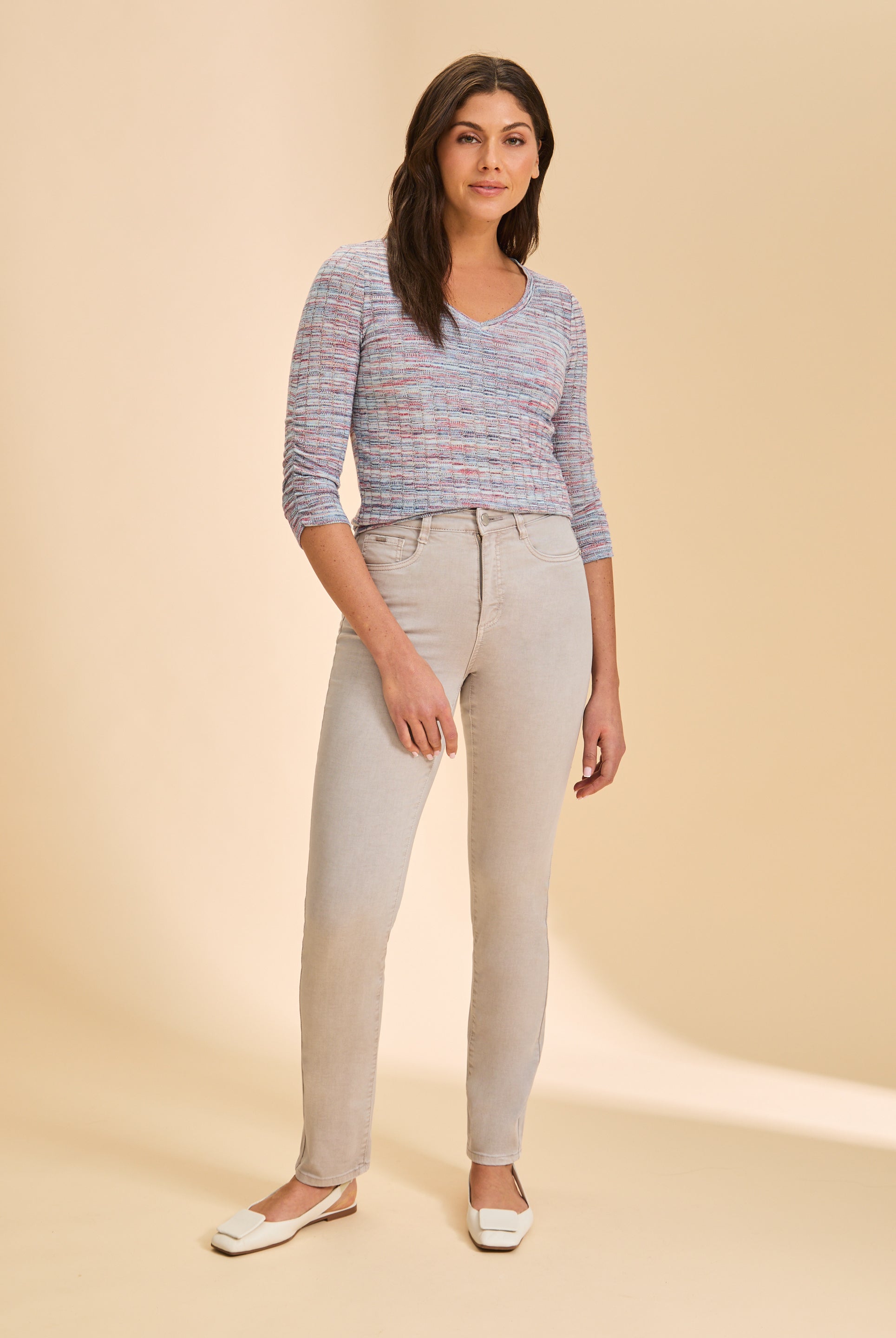 Full view of multicolor V-neck sweater styled with light pants by French Dressing Jeans (FDJ)