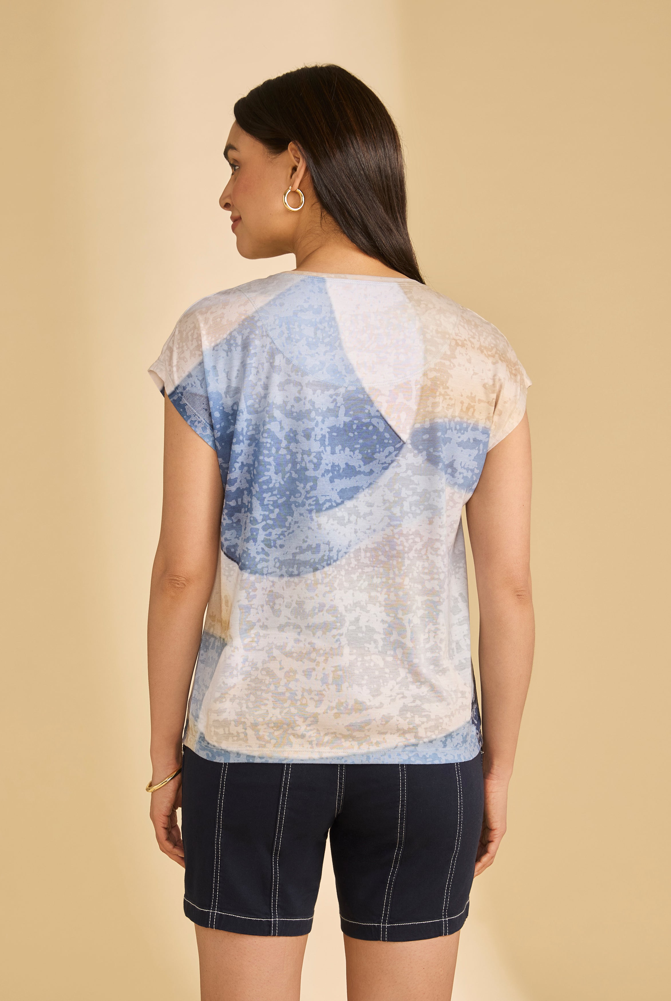 Back view of abstract blue and beige top with navy shorts highlighting casual summer look by French Dressing Jeans (FDJ)