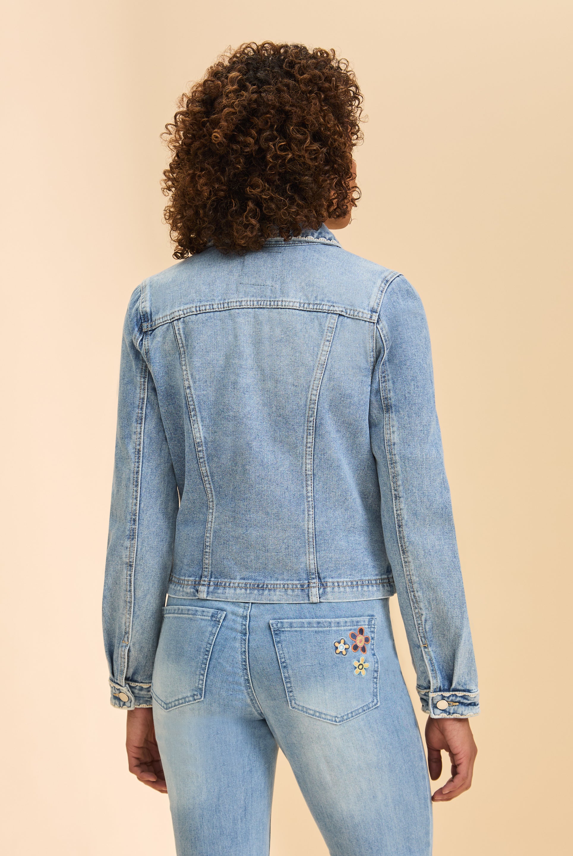 Back view of pale wash denim jacket highlighting seam details and long sleeves by French Dressing Jeans (FDJ)
