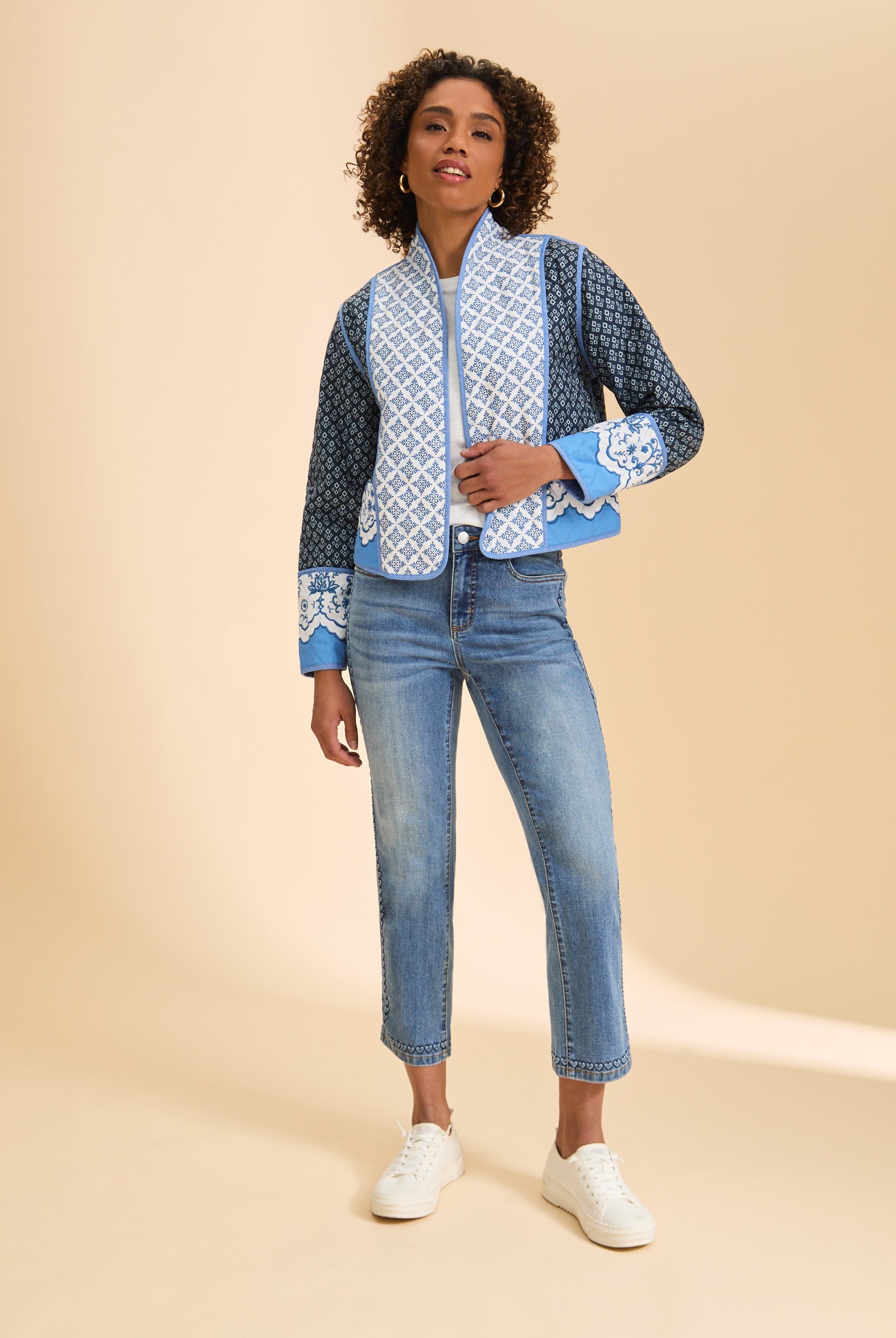 Full body view of patterned quilted jacket styled with jeans and sneakers by French Dressing Jeans (FDJ)