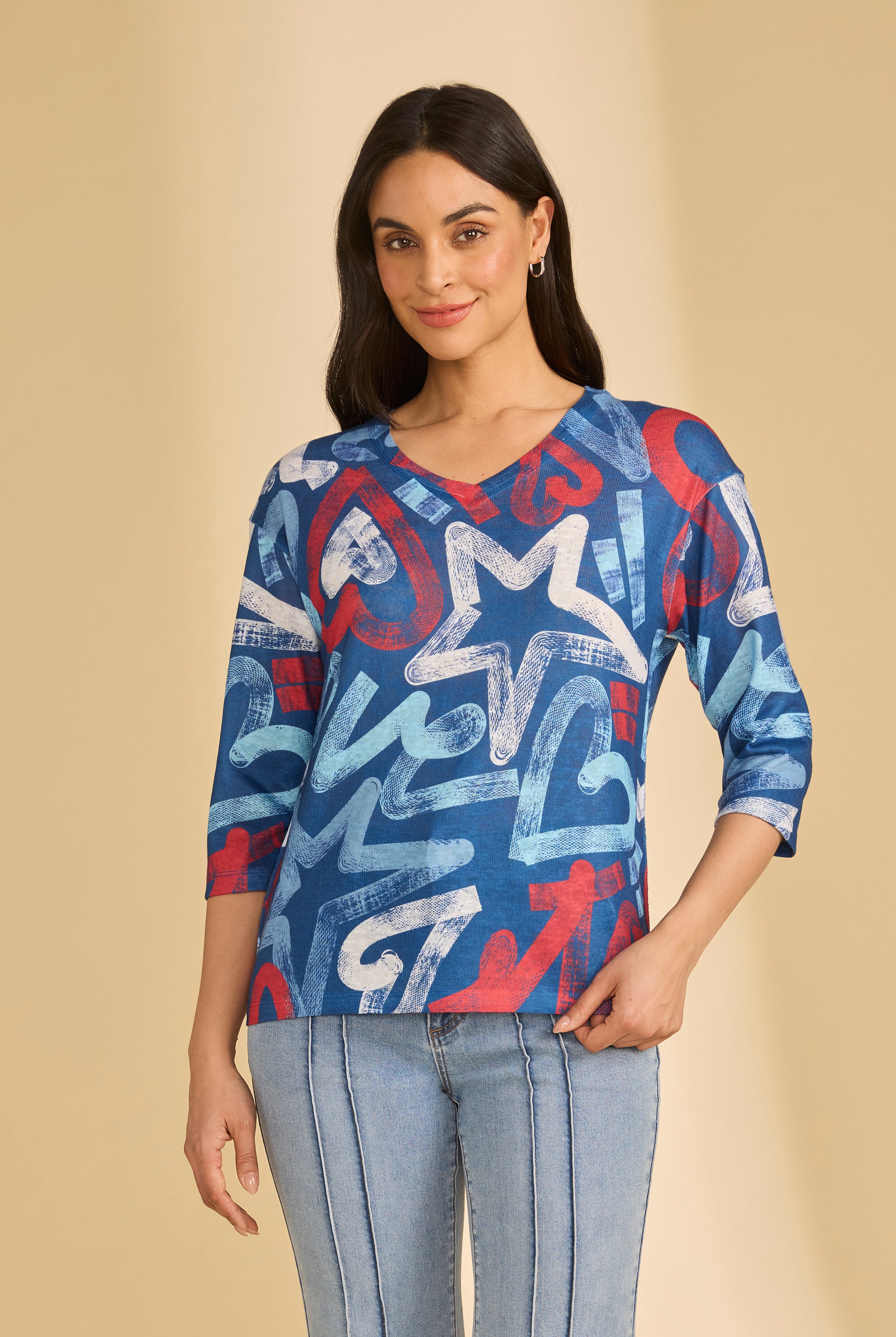 Front view of blue graphic V-neck top with bold star patterns by French Dressing Jeans (FDJ)