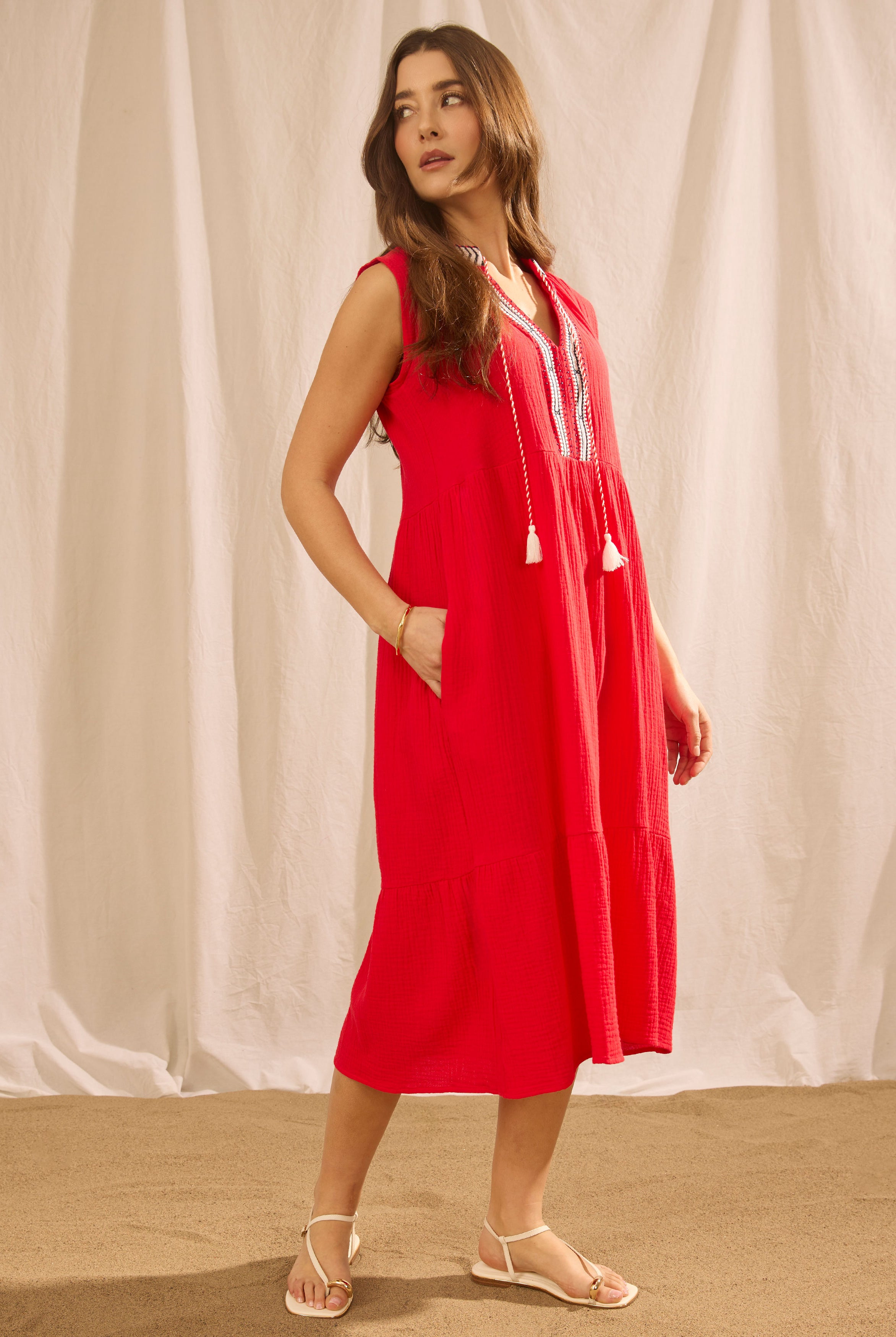 Side view of lava red sleeveless tiered midi dress with side seam pockets by French Dressing Jeans (FDJ)