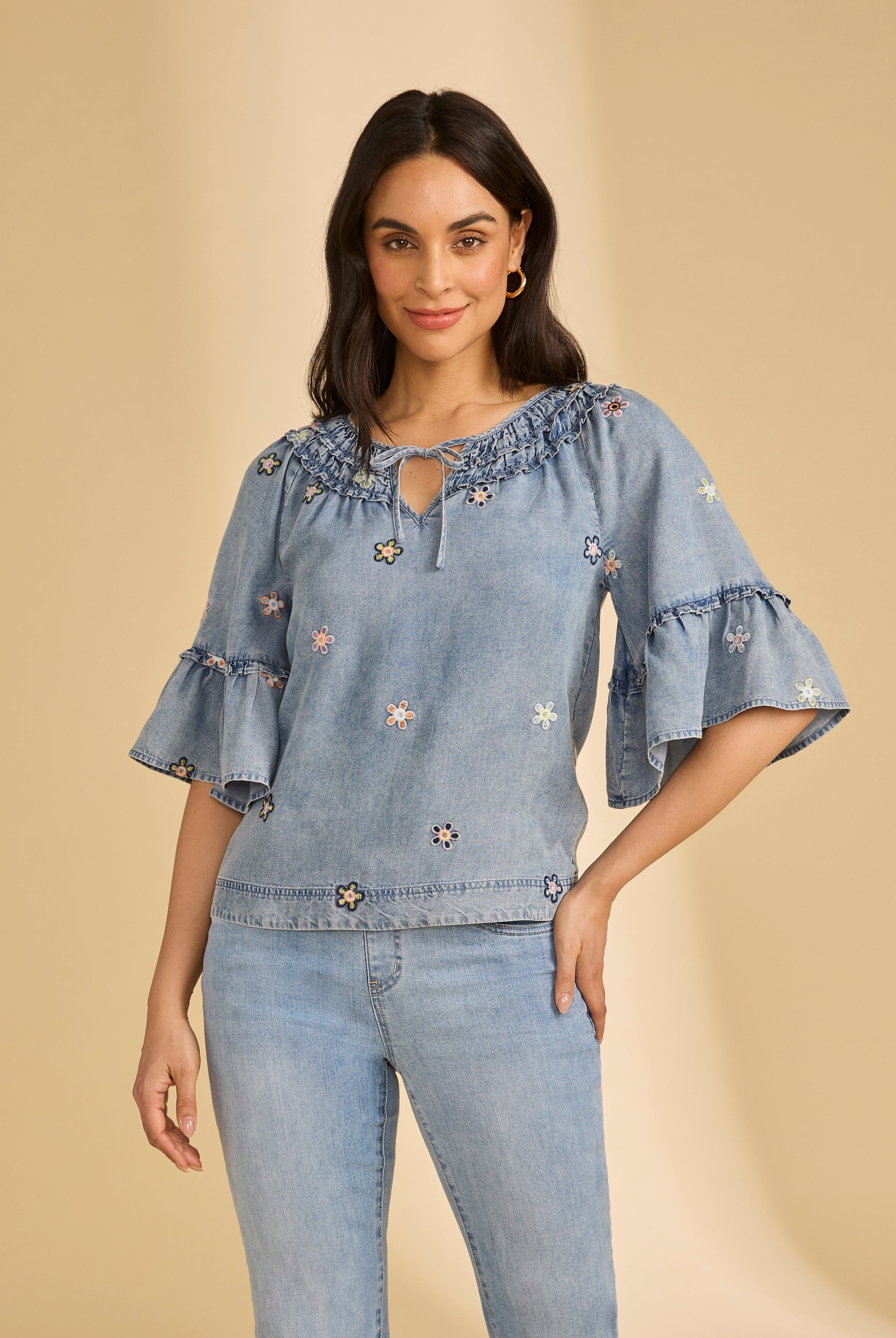 Front view of denim top with floral embroidery and ruffled neckline by French Dressing Jeans (FDJ)