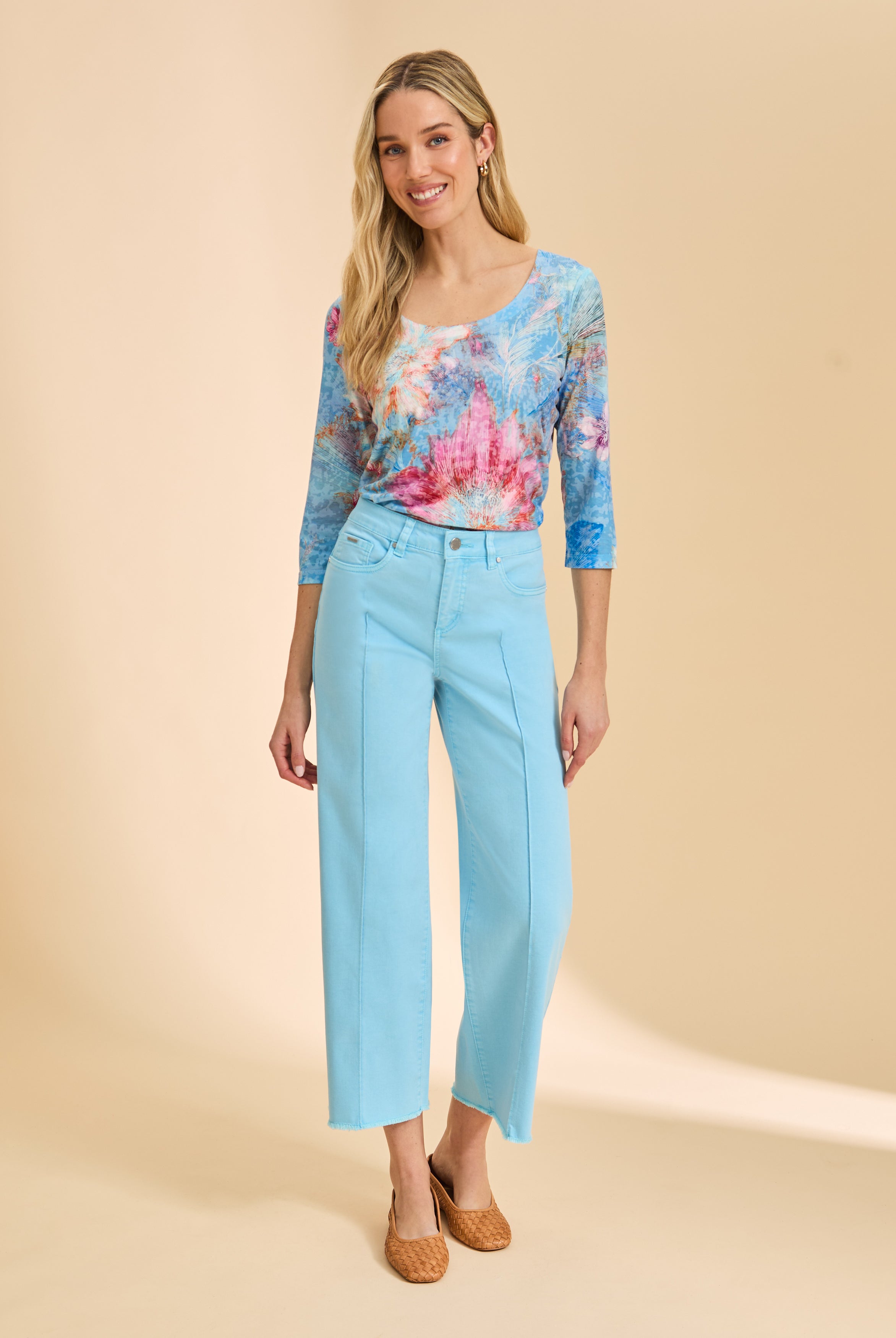 Full outfit view with blue floral top and light blue pants, highlighting scoop neck design by French Dressing Jeans (FDJ)
