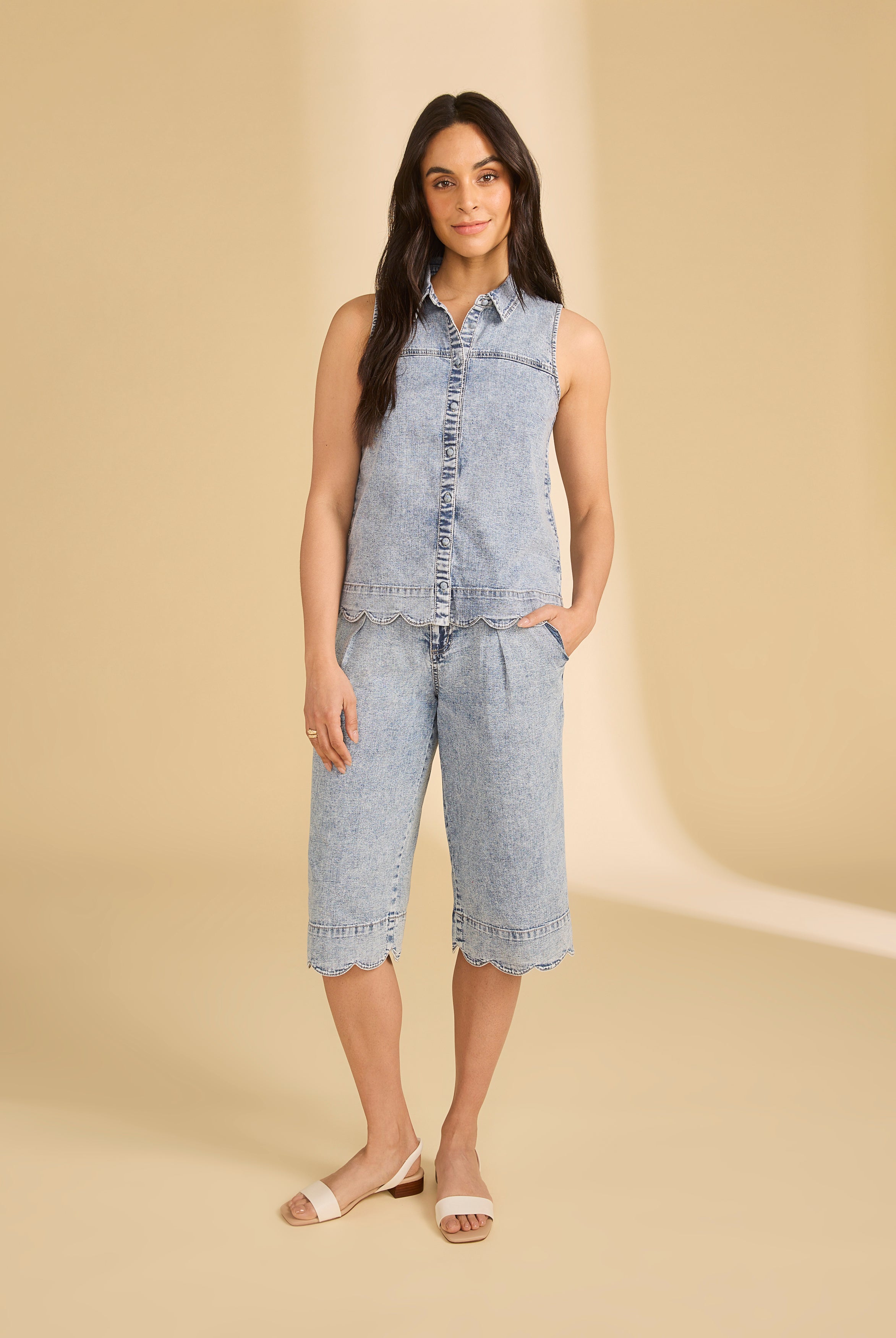 Model wearing sleeveless denim top with powder wash shorts in studio setting by French Dressing Jeans (FDJ)
