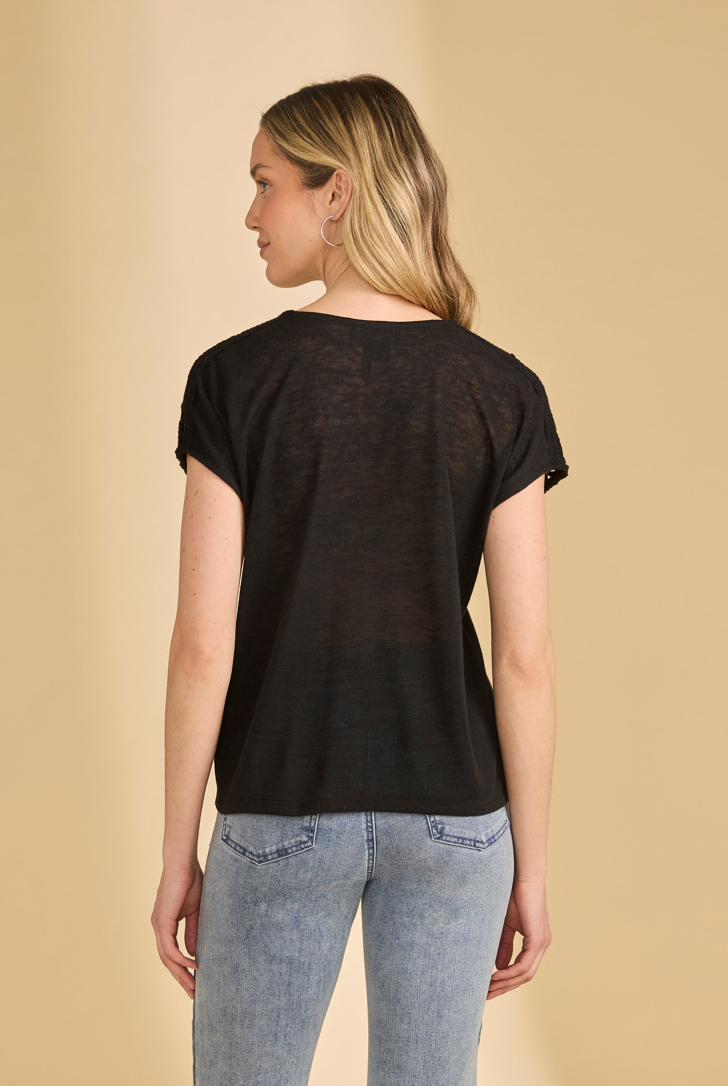 Back view of black V-neck top highlighting crochet shoulder details by French Dressing Jeans (FDJ)