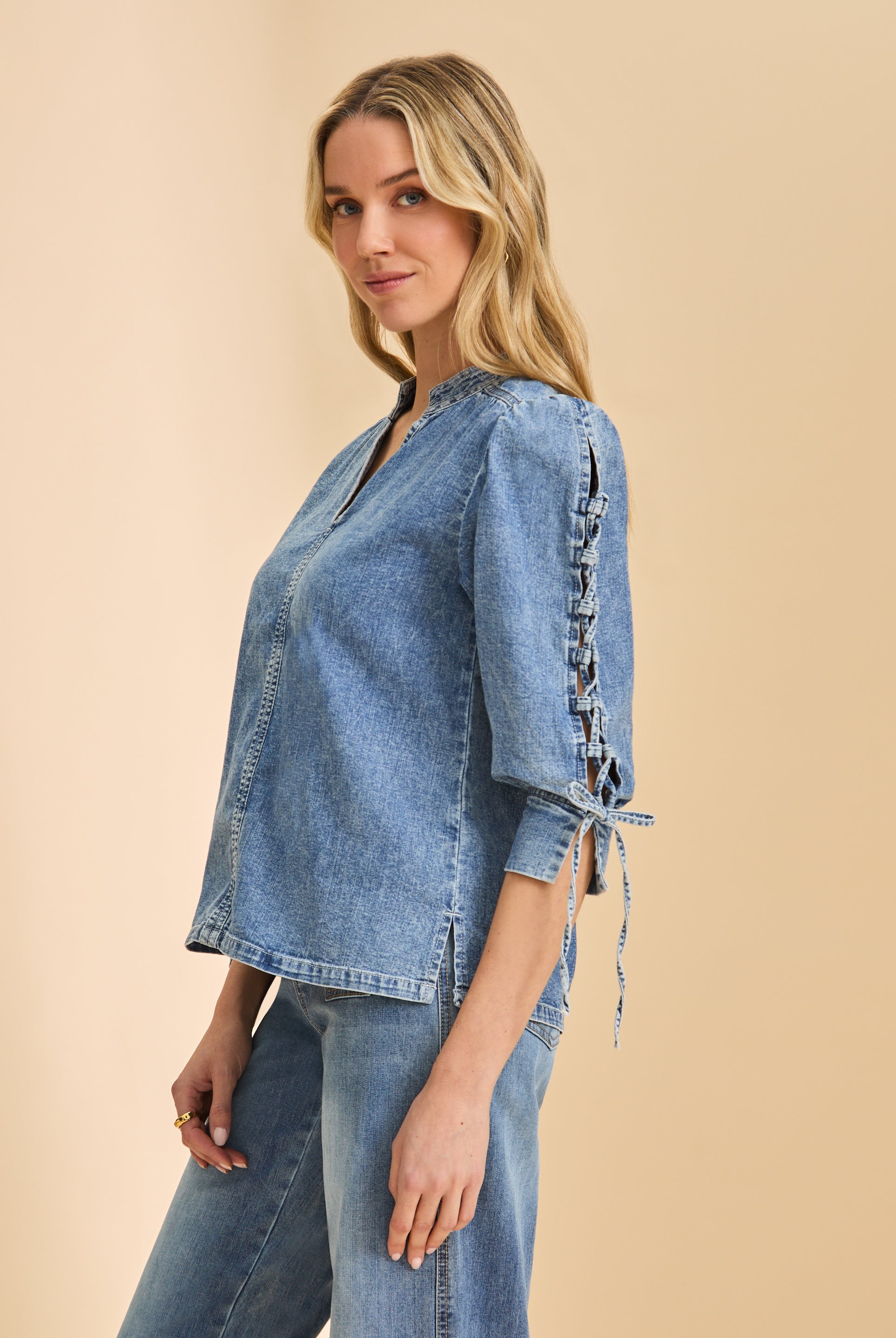 Side profile of chambray shirt emphasizing lace-up sleeve design by French Dressing Jeans (FDJ)