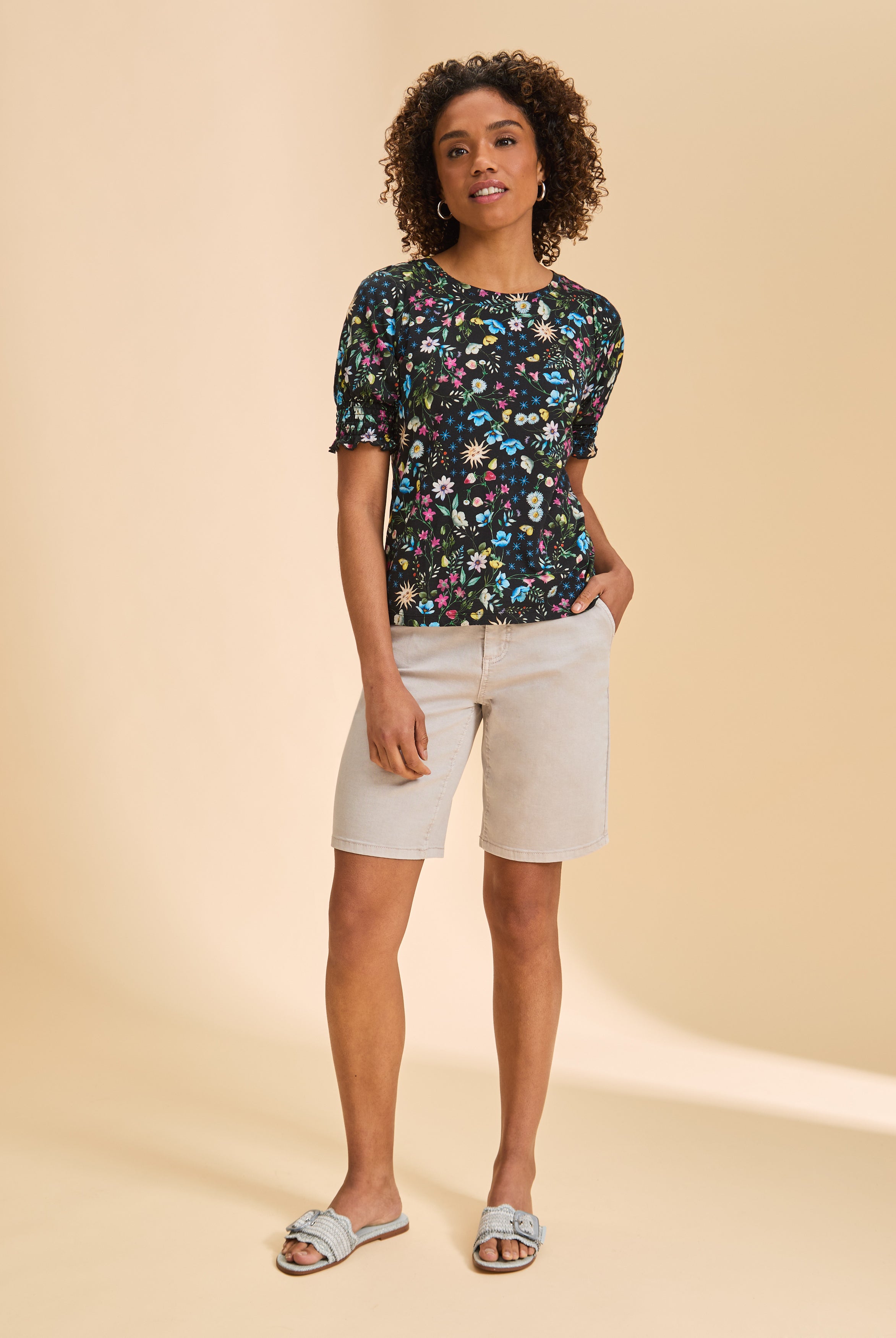 Full outfit with black floral top and light shorts highlighting summer look by French Dressing Jeans (FDJ)