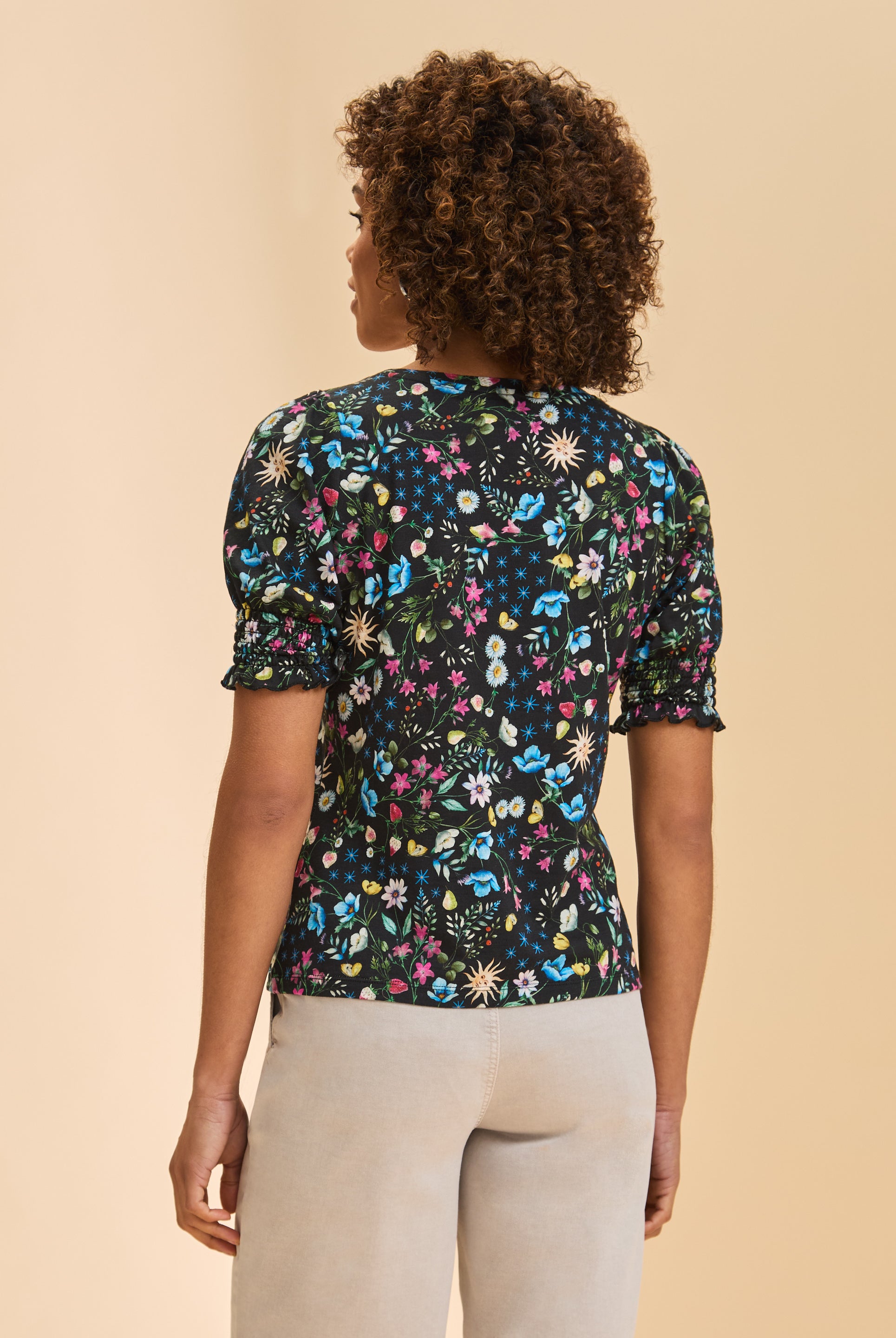 Back view of black floral top showing smocked sleeves and vibrant pattern by French Dressing Jeans (FDJ)