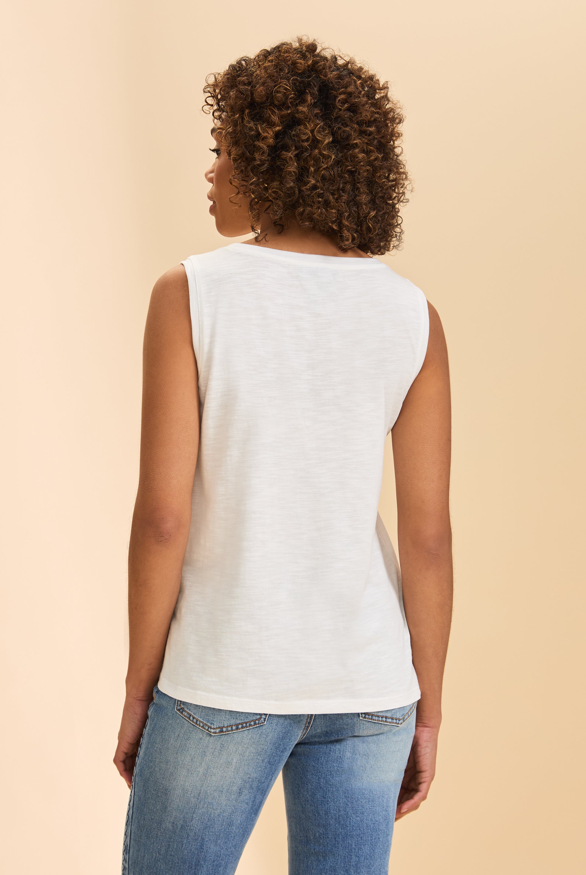 Back view of white sleeveless top displaying clean, minimalistic style by French Dressing Jeans (FDJ)