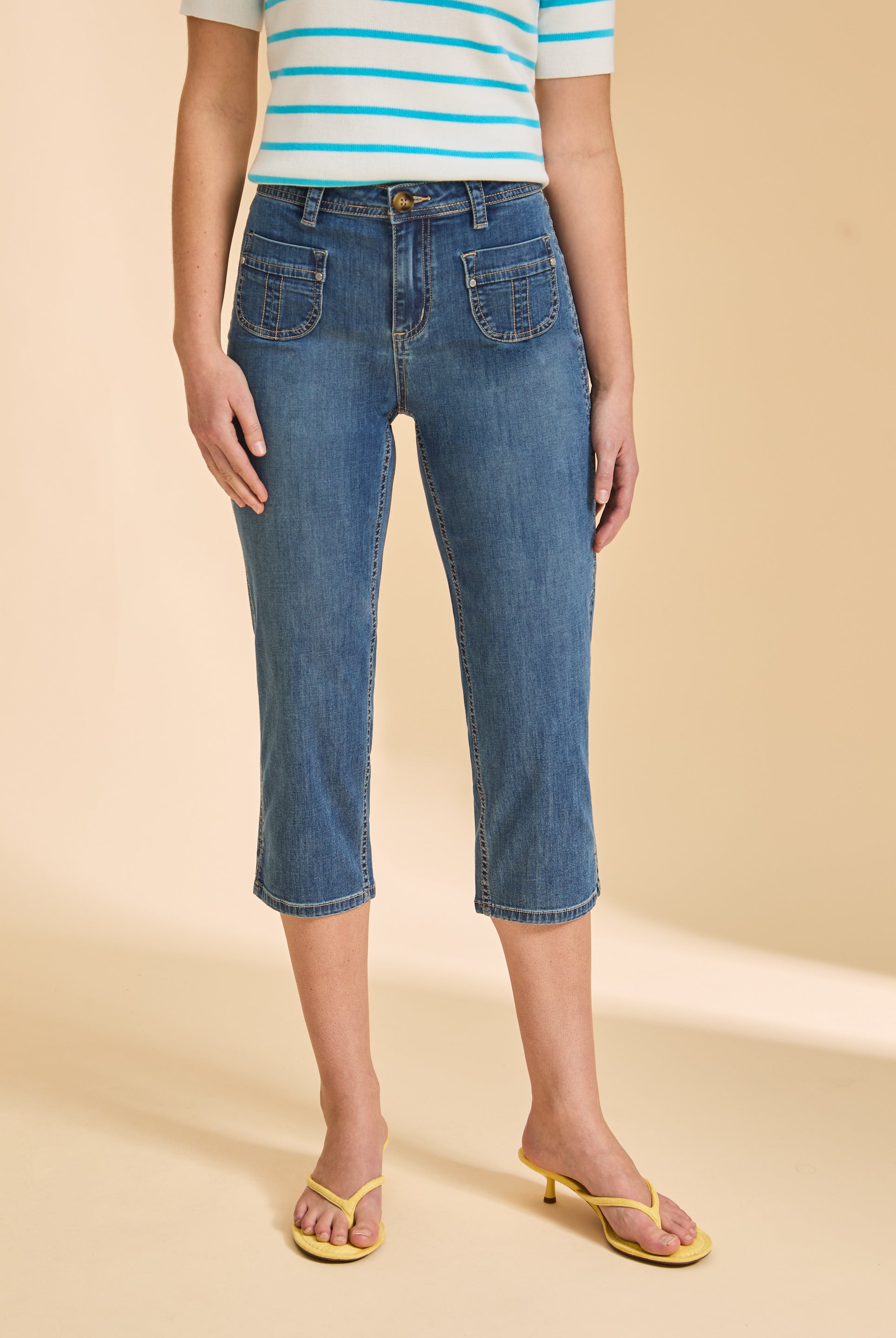Close-up of medium wash cropped jeans highlighting pocket details by French Dressing Jeans (FDJ)