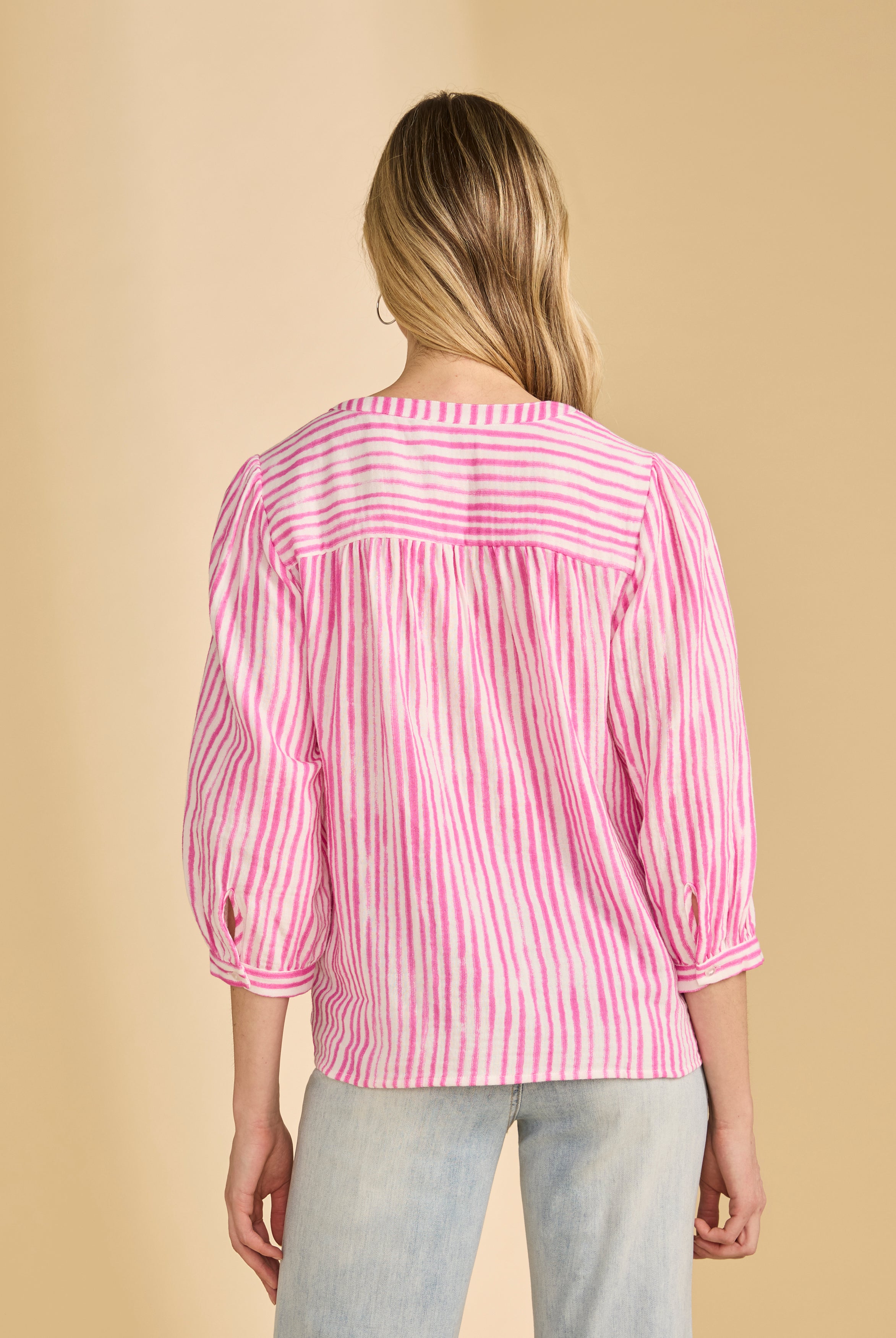 Back view of pink striped blouse highlighting yoke and pleats by French Dressing Jeans (FDJ)