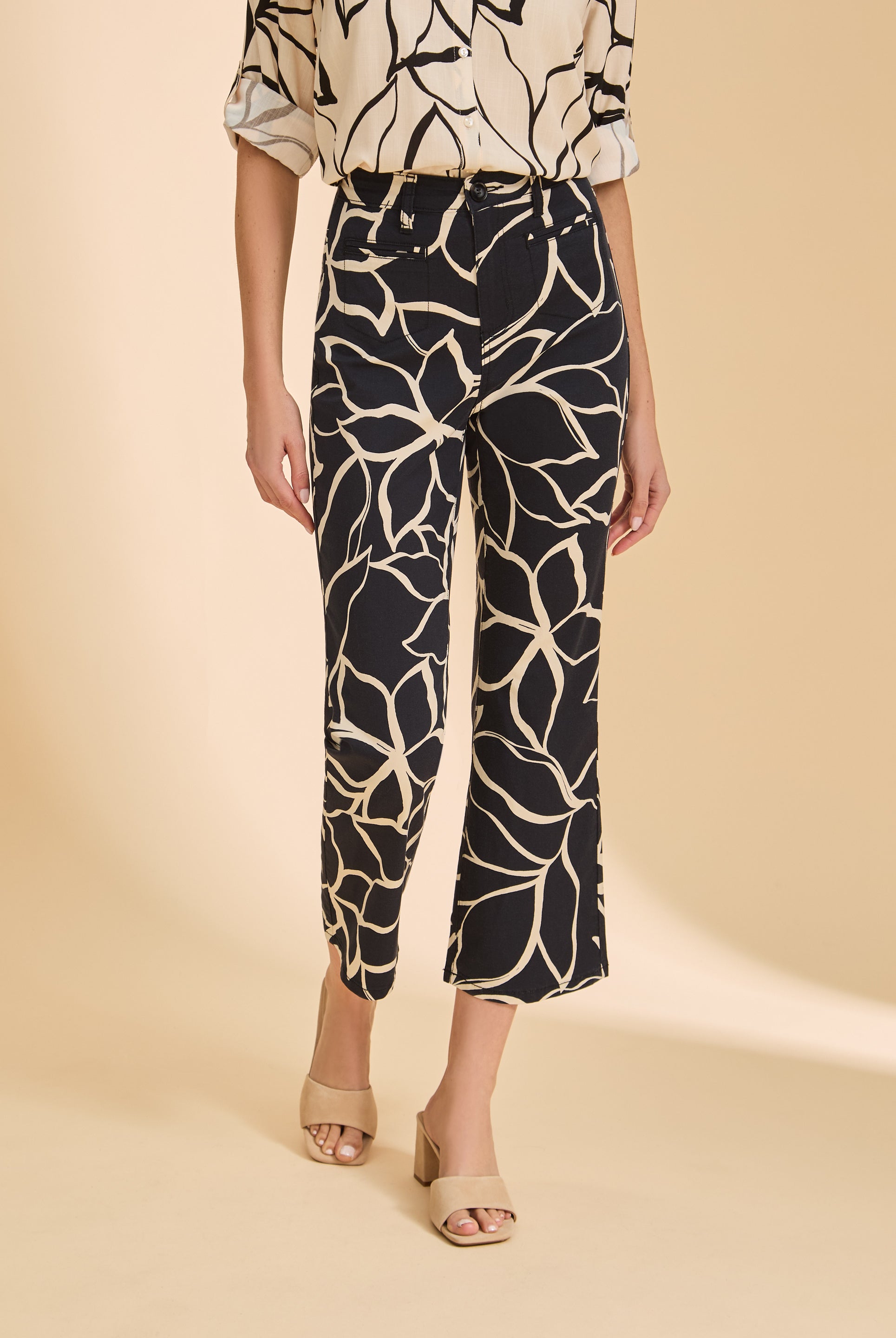 Close-up of black plumeria crop pants showcasing floral print and high-rise waist by French Dressing Jeans (FDJ)