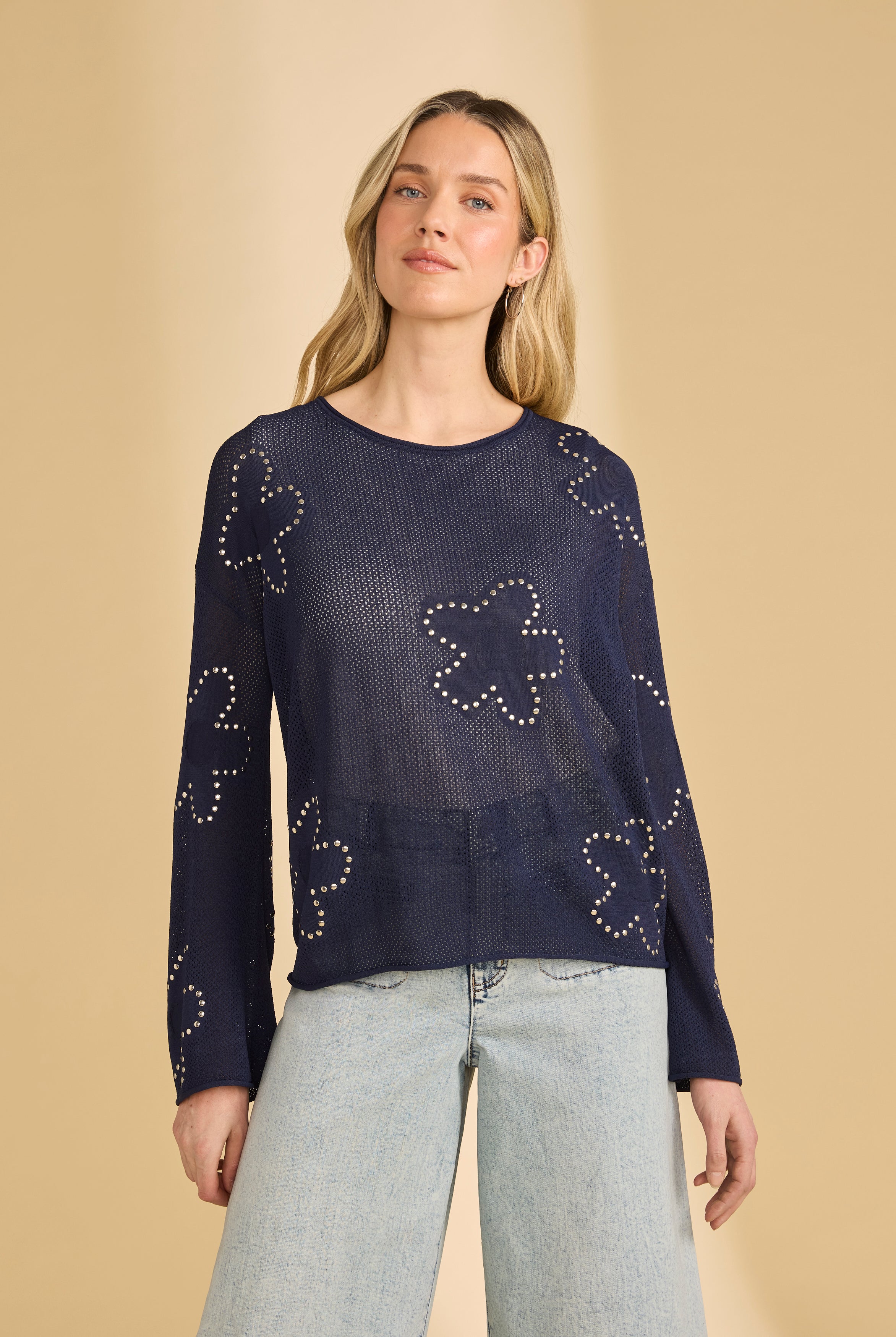 Front view of navy sweater with floral embellishments and sheer knit by French Dressing Jeans (FDJ)