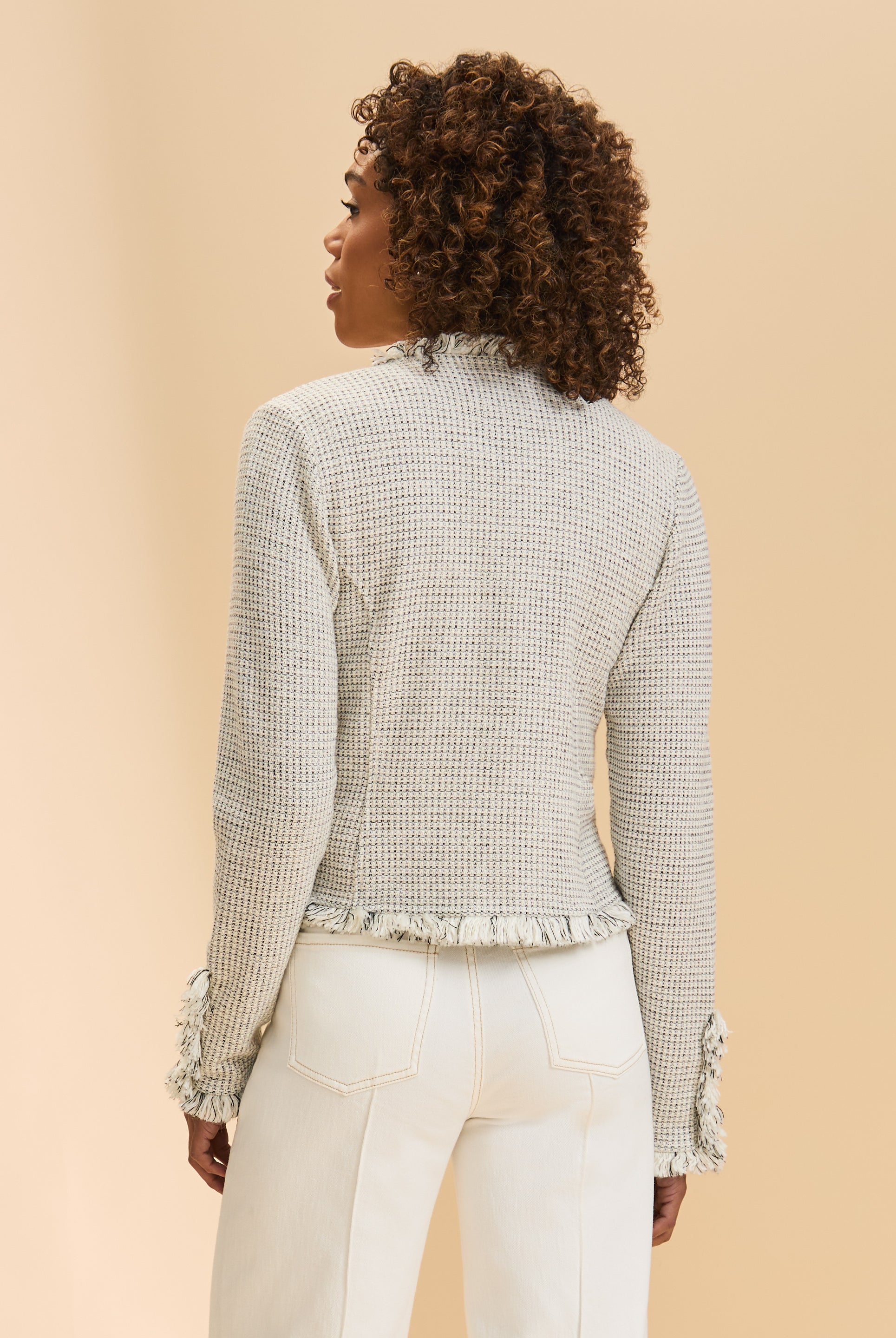 Back view of cream tweed jacket showcasing subtle check pattern and fringe by French Dressing Jeans (FDJ)