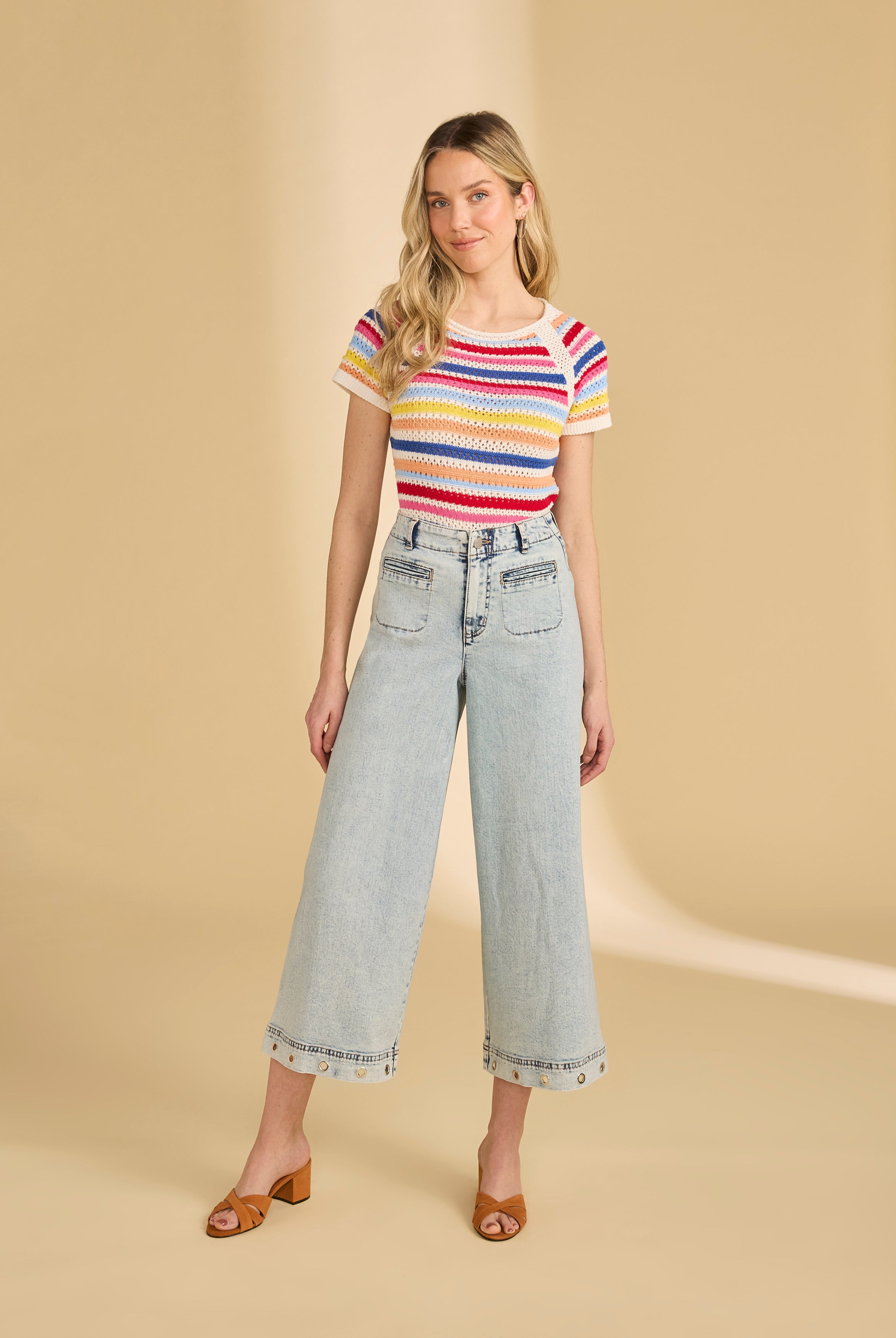 Full body view of multi-color stripe sweater styled with light denim jeans by French Dressing Jeans (FDJ)