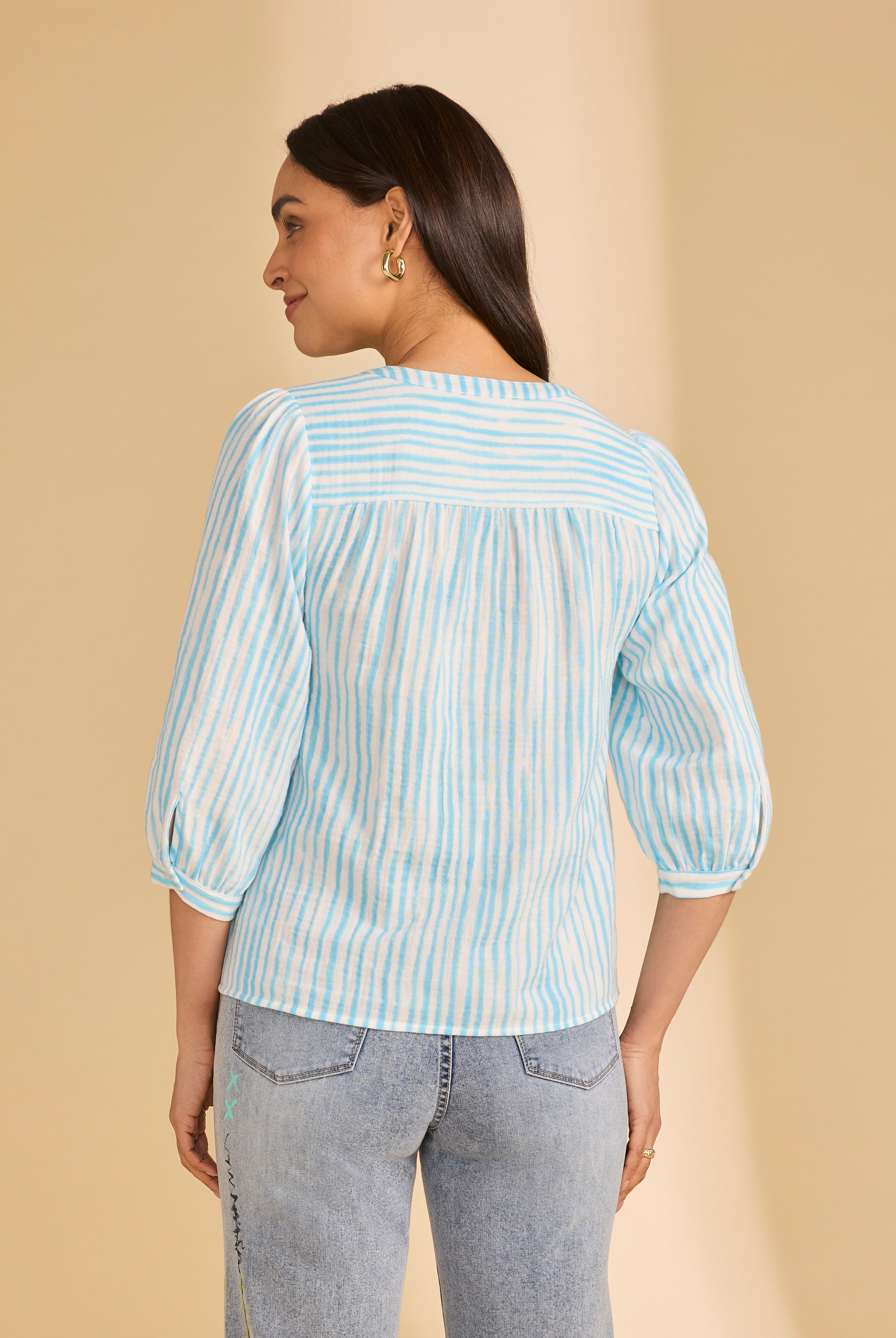 Back view of light blue striped blouse showing yoke and soft pleats by French Dressing Jeans (FDJ)