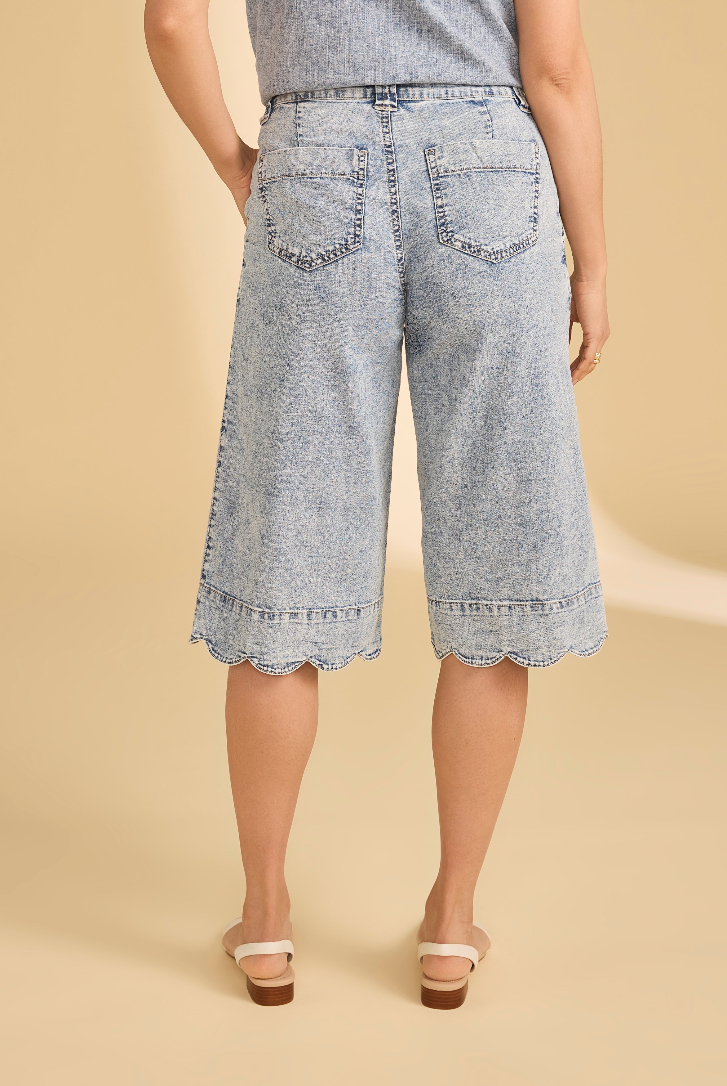 Back view of powder wash denim shorts displaying back pockets and scalloped hem by French Dressing Jeans (FDJ)