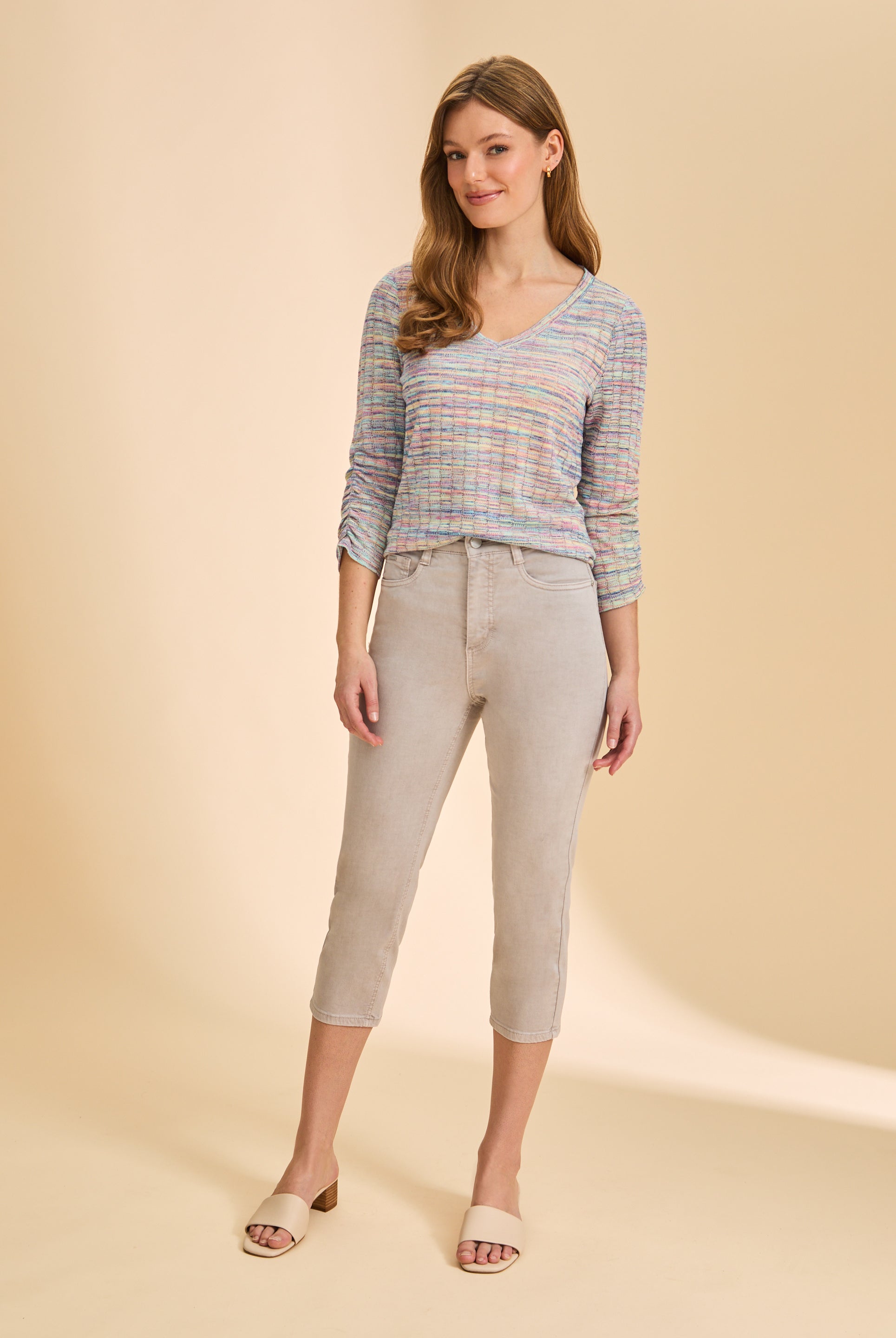 Full view of pastel multicolor V-neck sweater styled with cropped pants by French Dressing Jeans (FDJ)