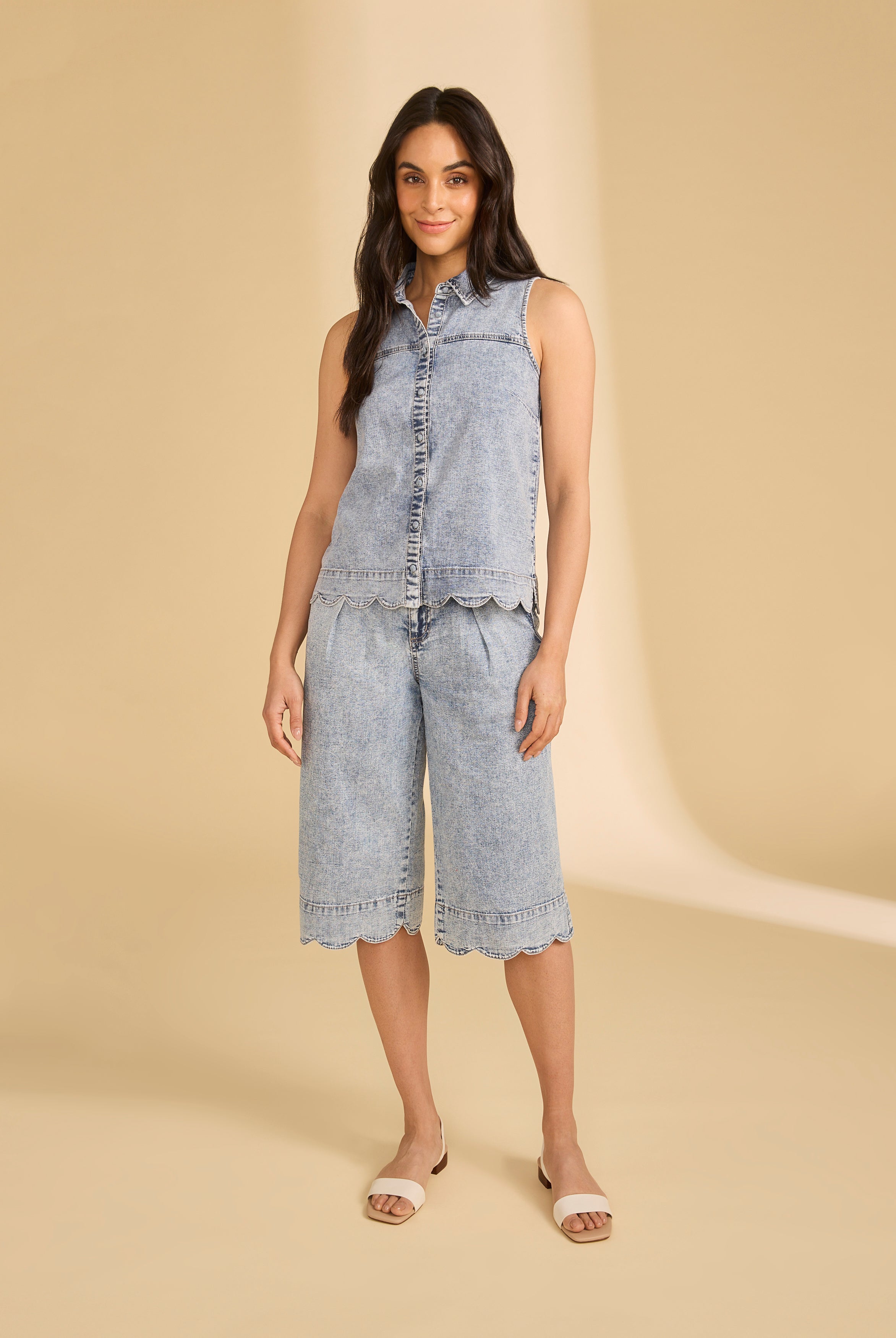 Full view of model in sleeveless denim top and shorts in powder wash by French Dressing Jeans (FDJ)