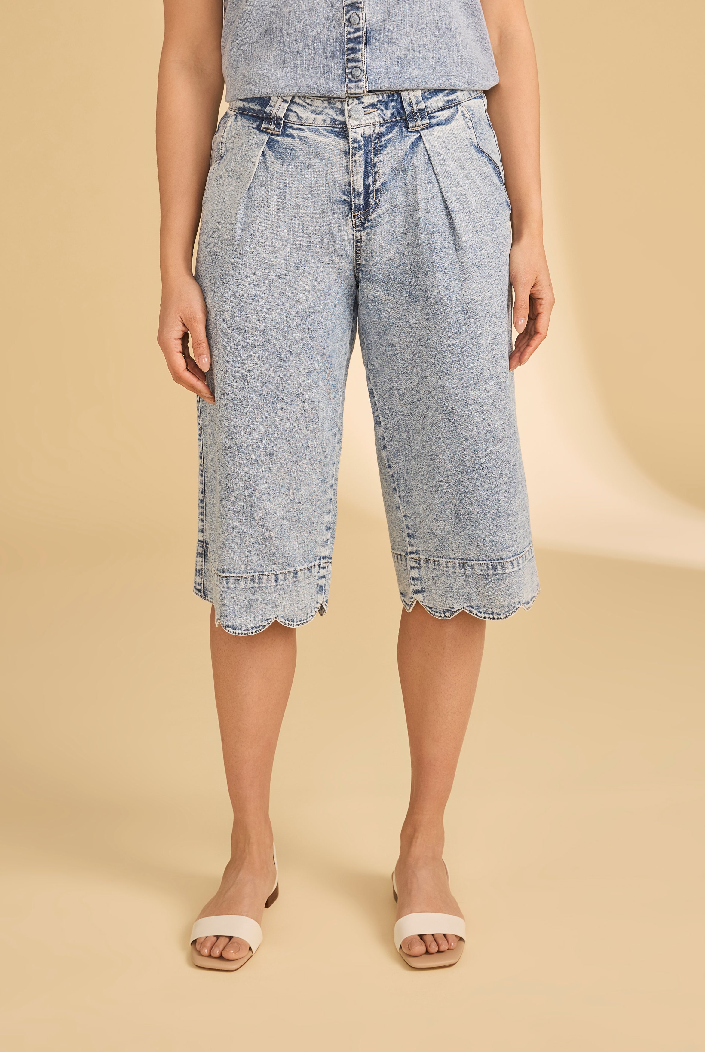 Front view of powder wash denim shorts with scalloped hem and pleats by French Dressing Jeans (FDJ)